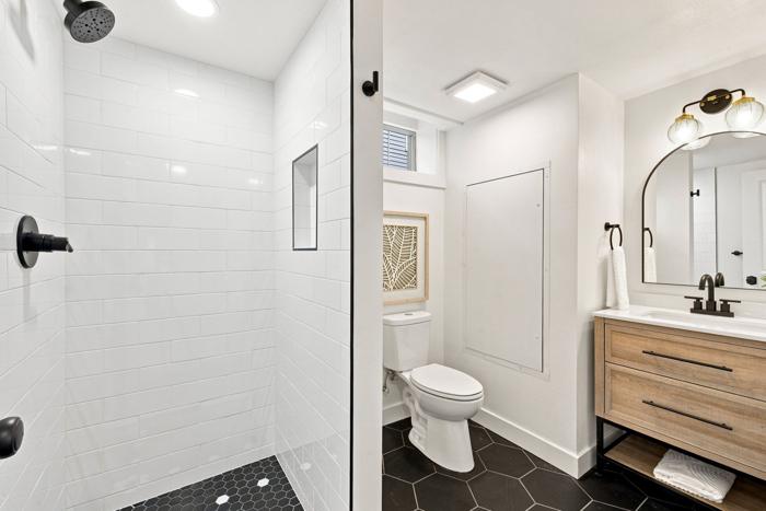 Basement bathroom. Subway-tile shower and hex tile floor