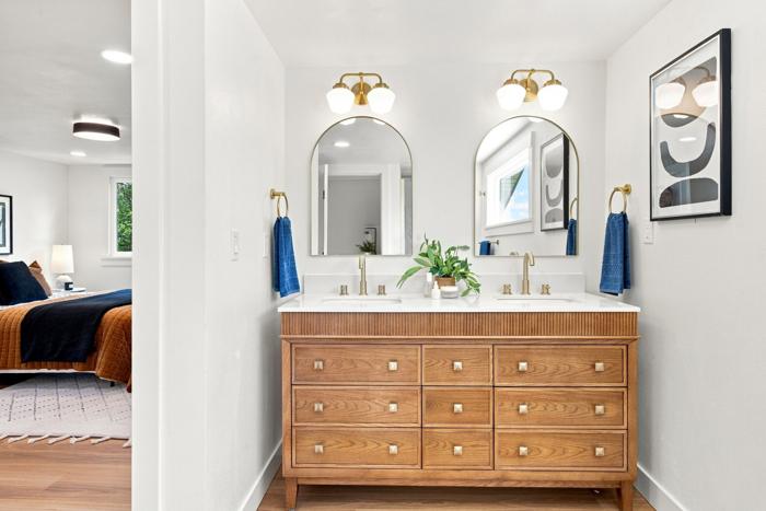 Double vanity. Furniture-style vanity with arched mirrors
