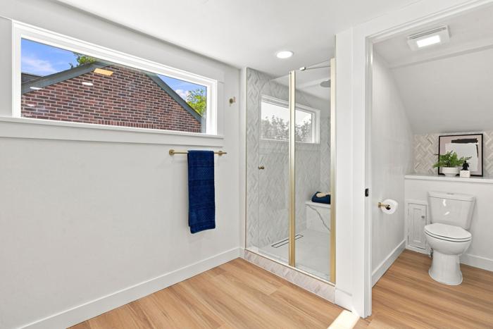 Primary bath. Walk-in shower with linear drain and glass enclosure